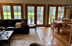 Great room with windows looking onto a deck and Eagle Vail Golf Course