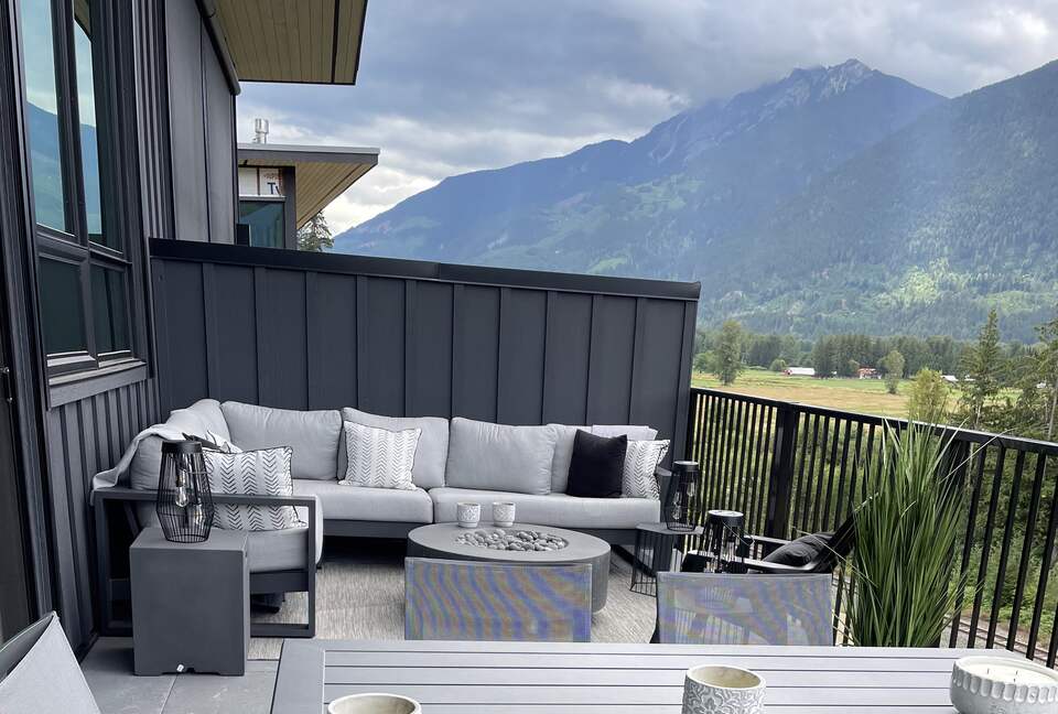 Main floor deck with fire pit, seating ,dining and BBQ.