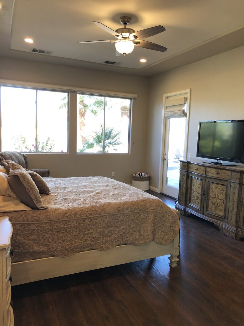 Primary bedroom with large screen TV with streaming