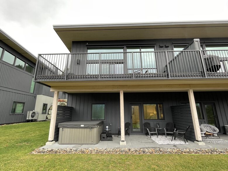 Rear of house with two decks, hot tub and yard