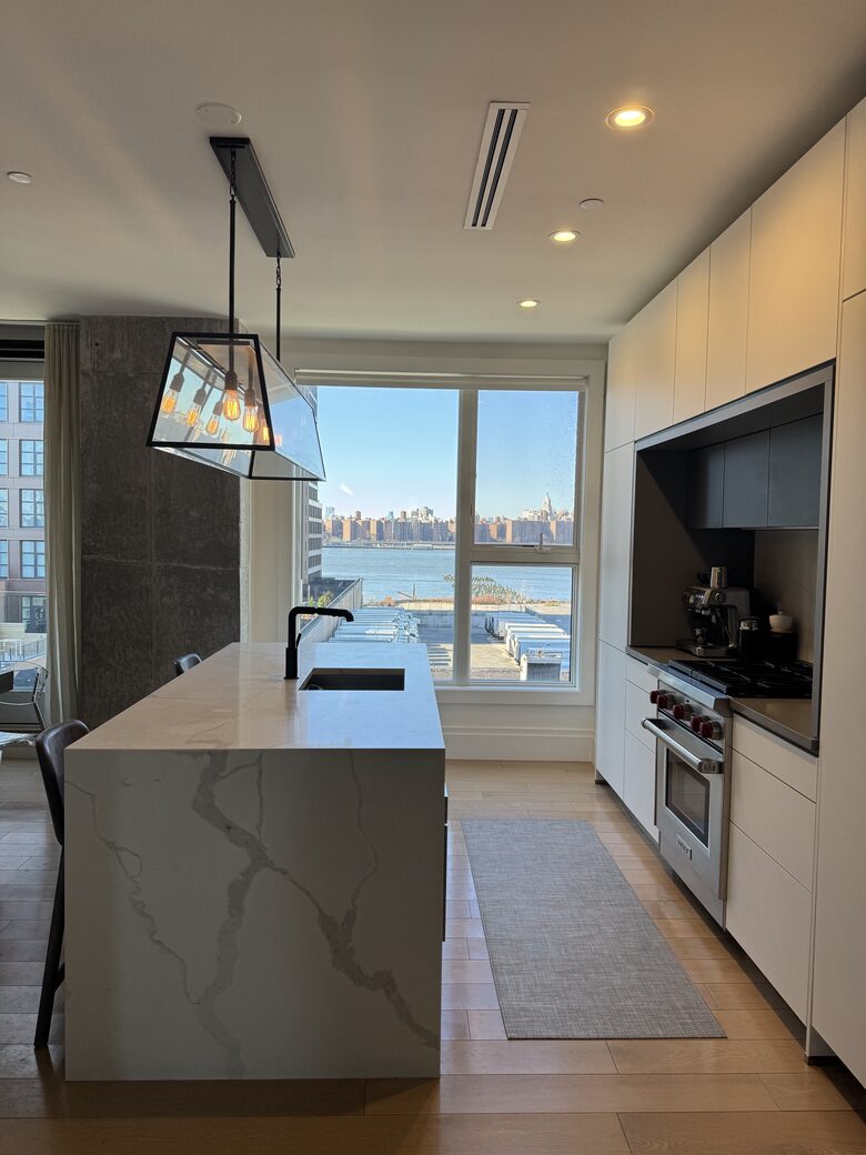 Kitchen on 1st fl. Floor-ceiling windows facing NYC, sunset views