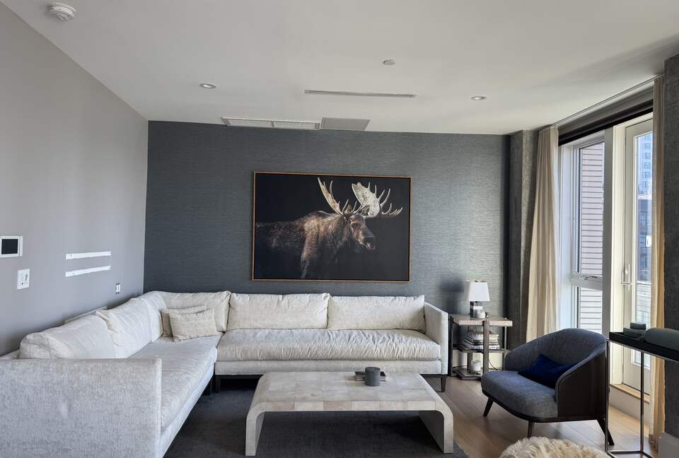 Living room on 1st fl.  Floor-ceiling windows facing NYC, sunset views