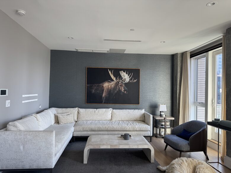 Living room on 1st fl. Floor-ceiling windows facing NYC, sunset views
