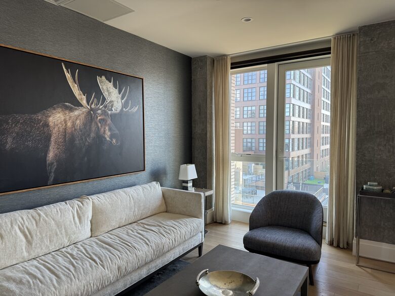 Living room on 1st fl. Floor-ceiling windows facing NYC, sunset views