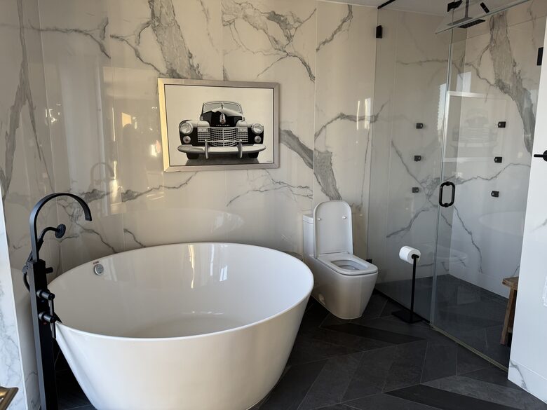 Primary bath 2nd fl. Floor-ceiling windows facing east, sunrise view