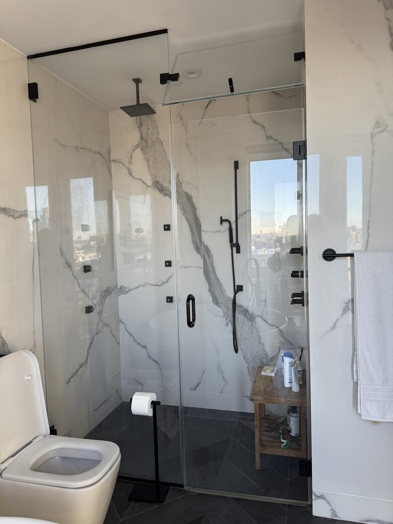 Primary bath 2nd fl. Floor-ceiling windows facing east, sunrise view