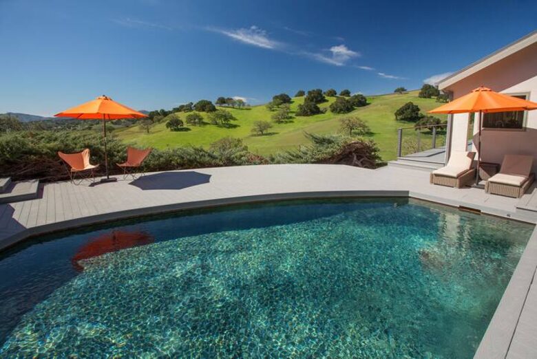 Pool and hot tub with view of the hills
