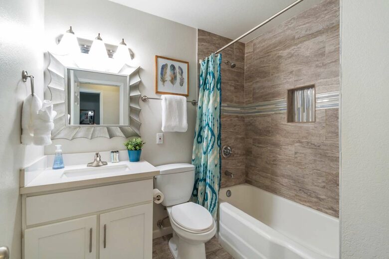 Guest bathroom with single sink and tub/shower combo