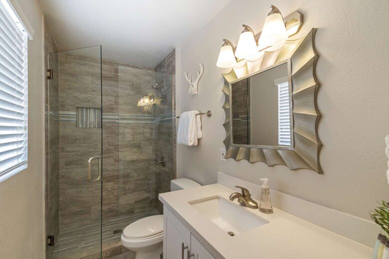 Master bathroom with single sink and walk in shower