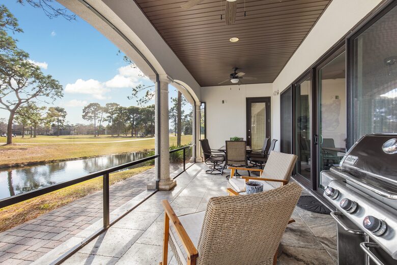 Screened patio with grill and dining area