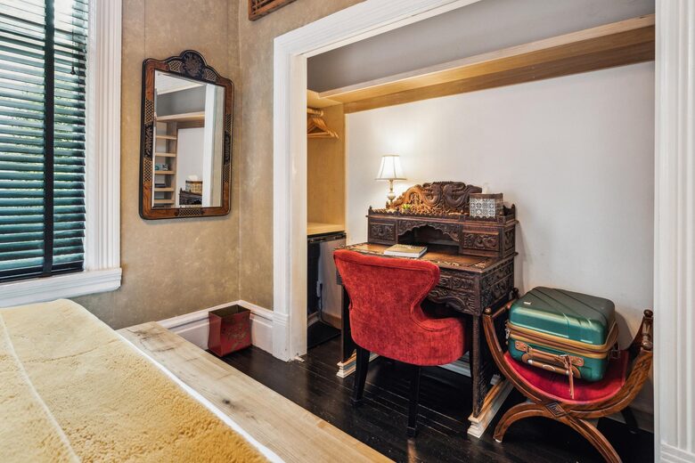2F Orchard: A small writing space, chair, and a mini fridge