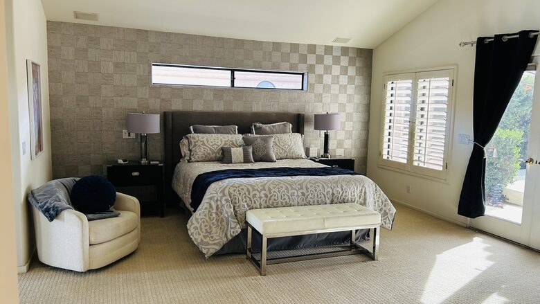 Master bedroom with views of yard spa and pool