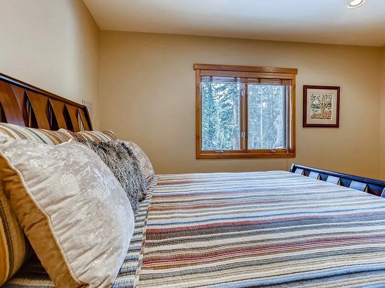 King downstairs bedroom with forest view