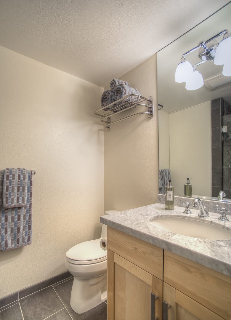 Bunkroom bathroom with custom shower and marble vanity