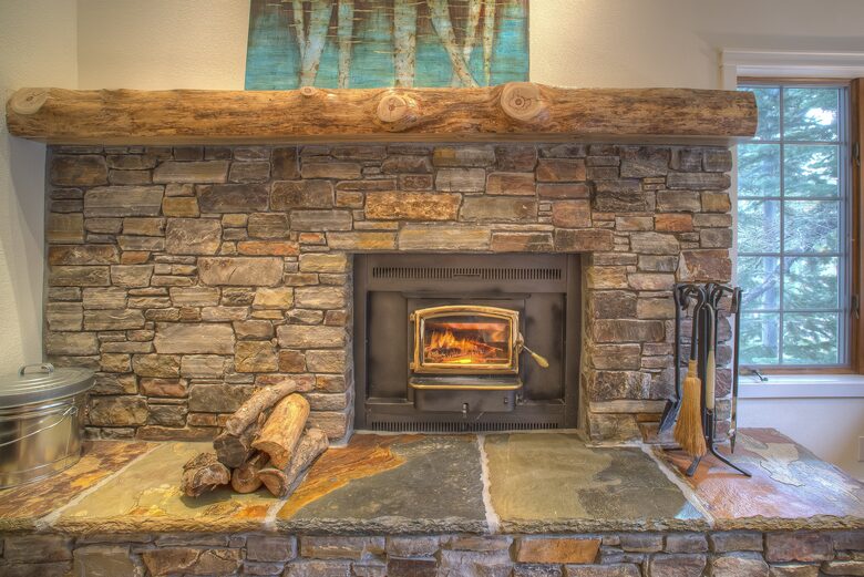 Real wood fireplace with logs and starters provided.
