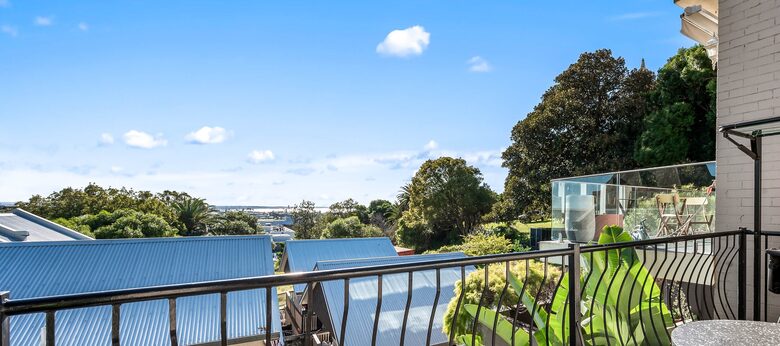 Sun-filled balcony with views across the coastline.