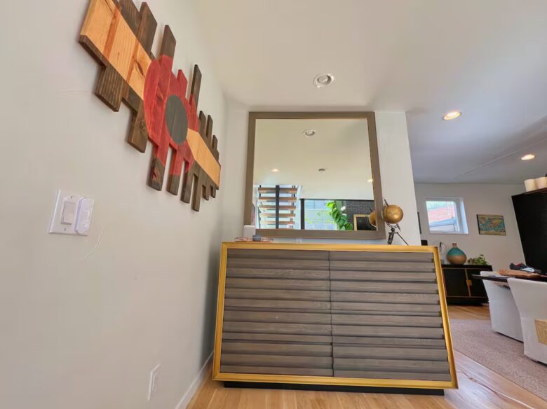 Luxury credenza with mirror above basement stairway