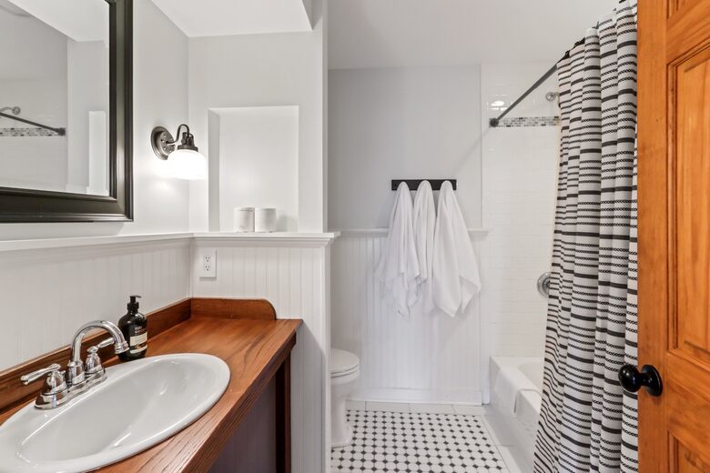 Second floor bathroom with sink, toilet, shower/tub combo