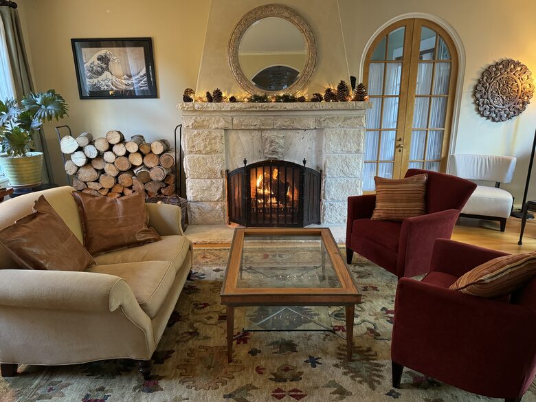 The living room with a travertine fireplace