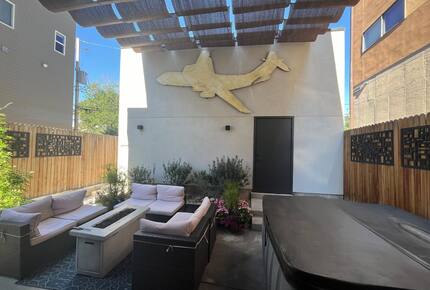 Backyard outdoor space with fire pit and hot tub