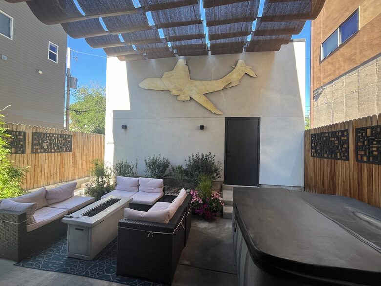 Backyard outdoor space with fire pit and hot tub