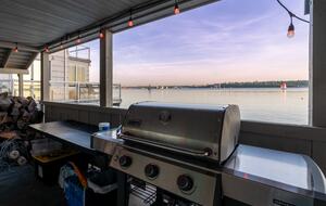 Covered BBQ area and cornhole on the lower deck.