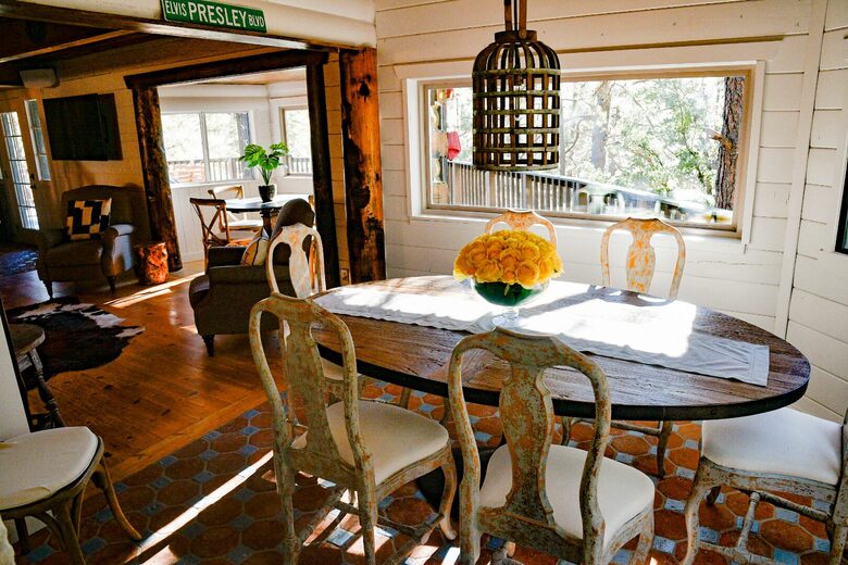 Formal dining area with windows looking out at forest
