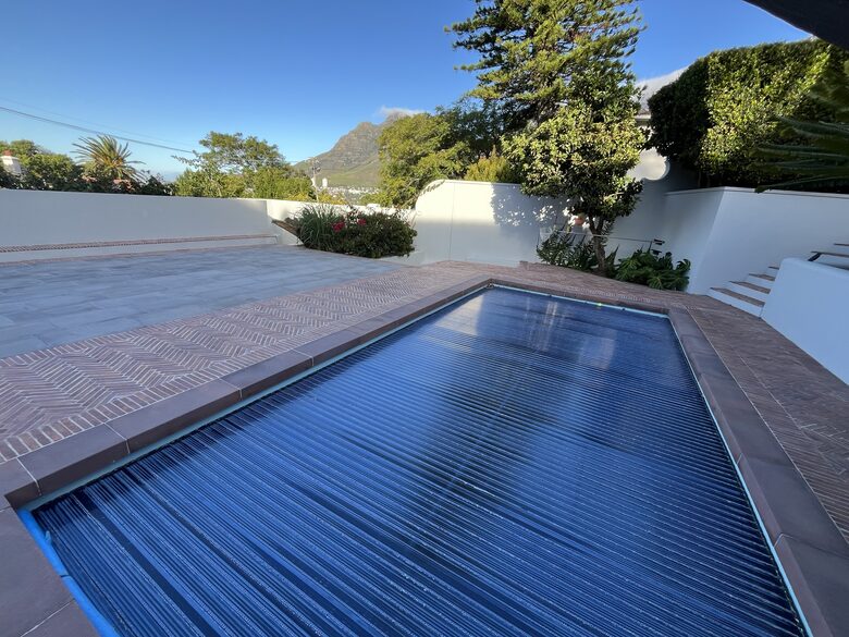 Automated Solar Heating Pool Cover | pool is serviced weekly