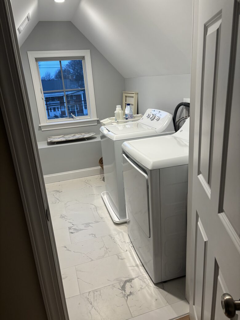Laundry room with full-size washer dryer and ironing center