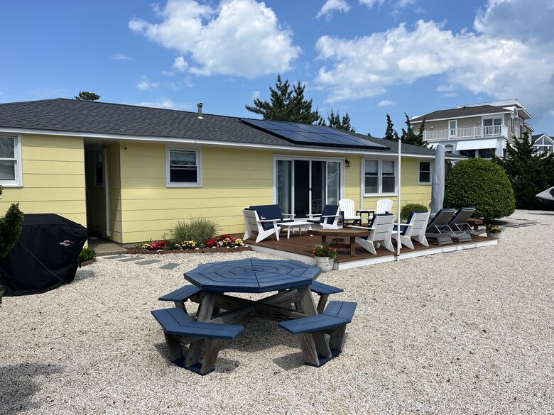 Back yard with deck, picnic table and hammock
