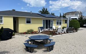 Back yard with deck, picnic table and hammock