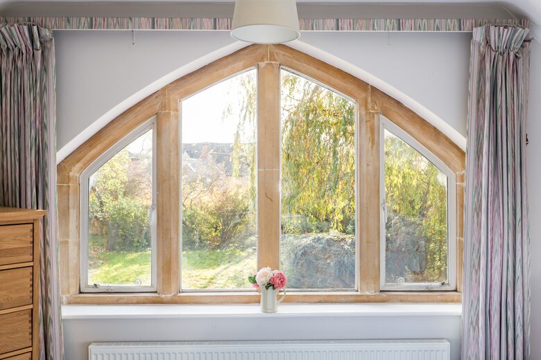 Master bedroom stone mullion window
