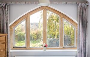Master bedroom stone mullion window