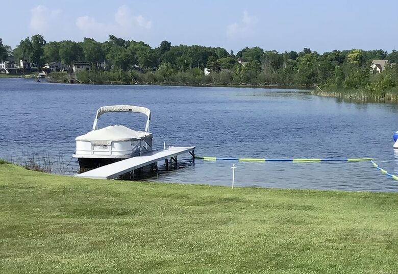 Sandy bottom swim area and boat dock
