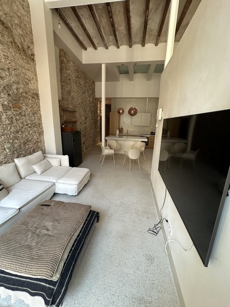 Open living space with 5m ceilings, and original walls