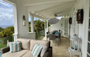 Outdoor living and dining area with Caribbean Sea views